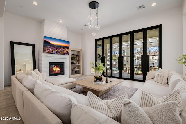 living room featuring a fireplace and light hardwood / wood-style flooring