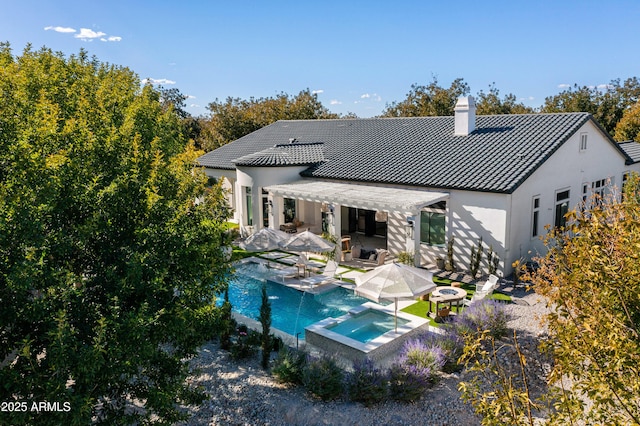 rear view of property with a patio, a pool with hot tub, and a pergola