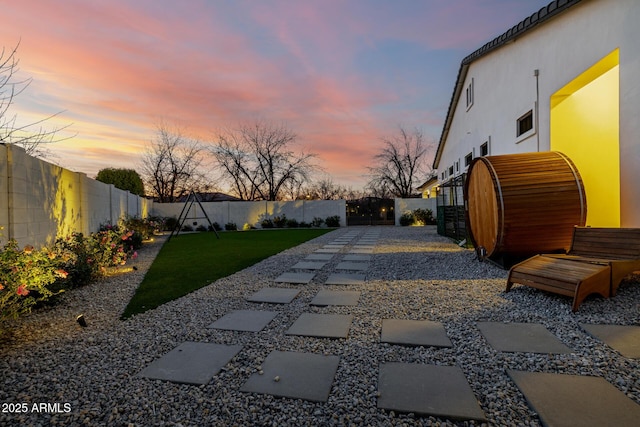 yard at dusk featuring a patio