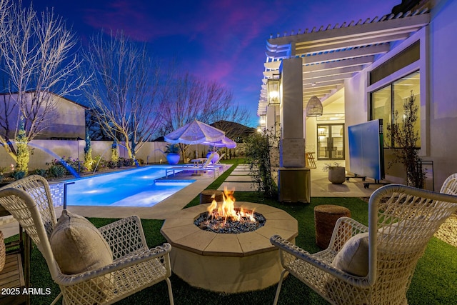 view of pool featuring a patio and a fire pit