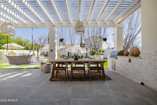 view of patio with a pergola, exterior kitchen, and grilling area