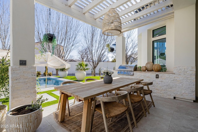 view of patio with area for grilling and a pergola