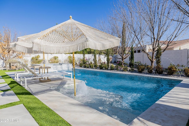 view of swimming pool with pool water feature