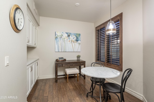 dining room with dark hardwood / wood-style flooring