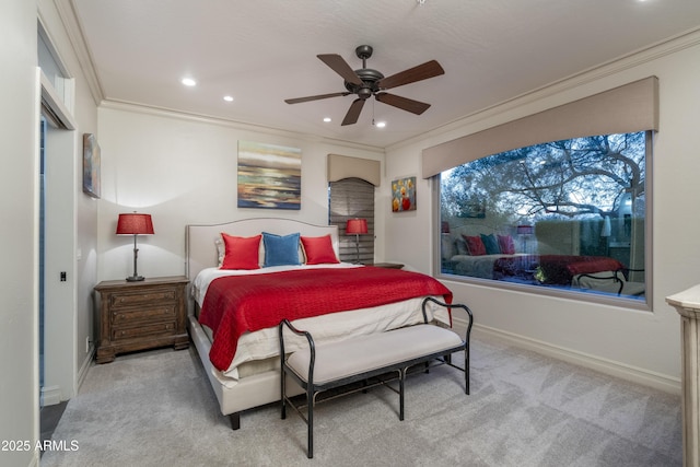 carpeted bedroom with ornamental molding and ceiling fan