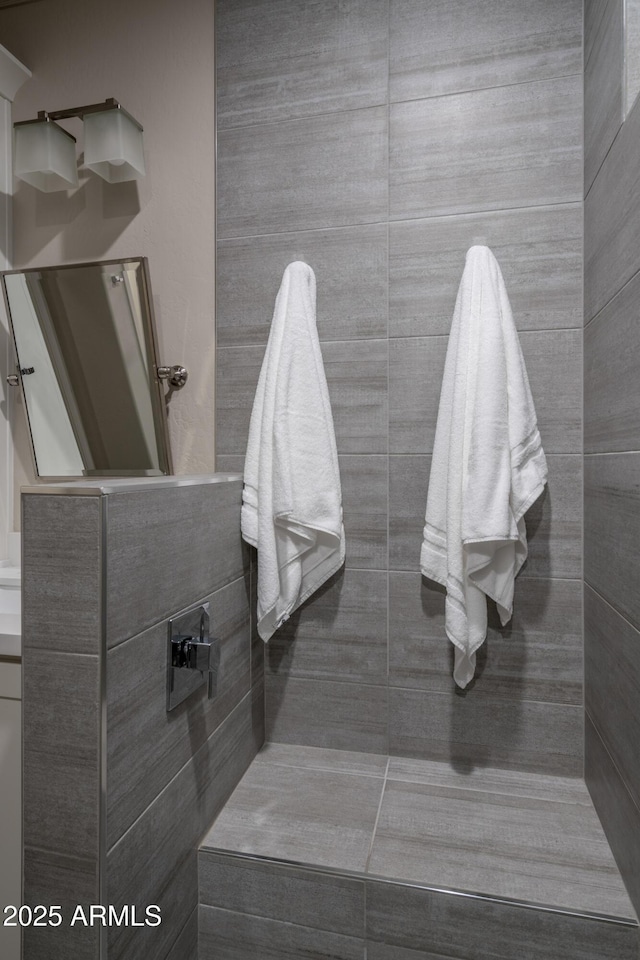 bathroom with a tile shower