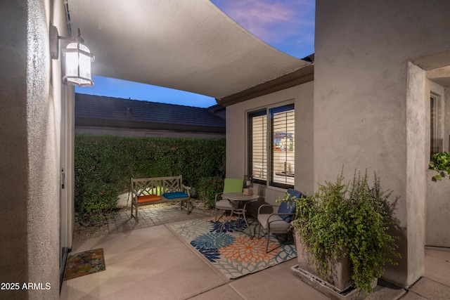 view of patio terrace at dusk