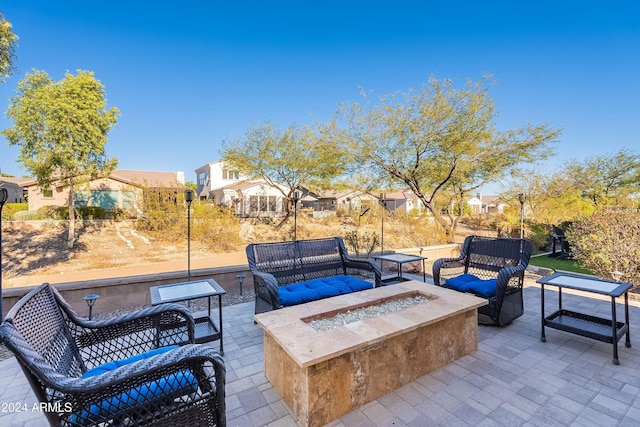 view of patio / terrace with an outdoor living space with a fire pit