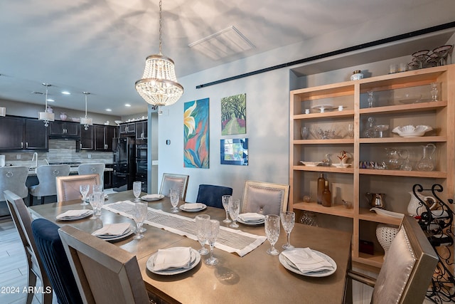 dining room featuring hardwood / wood-style floors and a notable chandelier