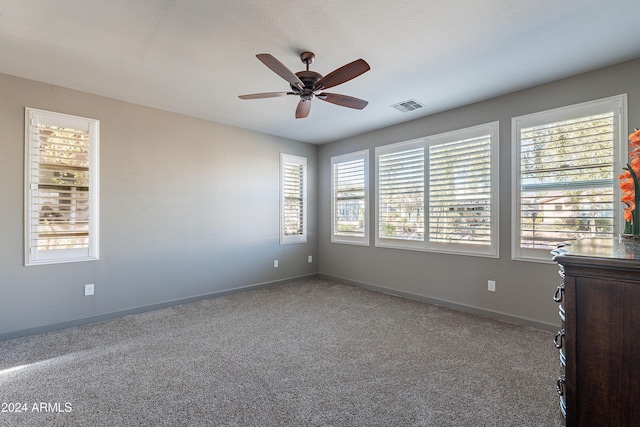 unfurnished bedroom featuring carpet floors and ceiling fan