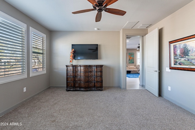 unfurnished bedroom with light colored carpet and ceiling fan