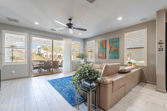 living room with ceiling fan and light wood-type flooring