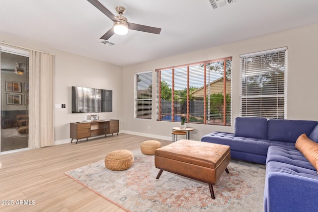 139 E Gail Dr, Gilbert, AZ 85296 - living area featuring a ceiling fan, light wood finished floors, and baseboards