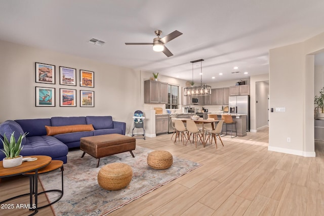 139 E Gail Dr, Gilbert, AZ 85296 - living room with light wood-style flooring, a ceiling fan, baseboards, and recessed lighting