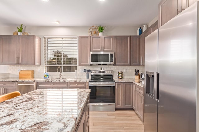 139 E Gail Dr, Gilbert, AZ 85296 - kitchen featuring stainless steel appliances, a sink, backsplash, light stone counters, and recessed lighting