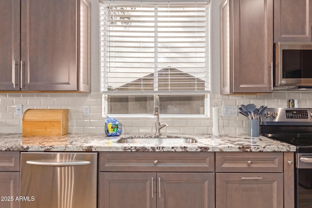 139 E Gail Dr, Gilbert, AZ 85296 - kitchen with stainless steel appliances, a sink, tasteful backsplash, and light stone countertops