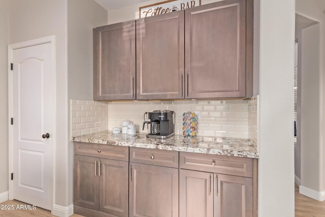 139 E Gail Dr, Gilbert, AZ 85296 - kitchen featuring baseboards, backsplash, and light stone counters