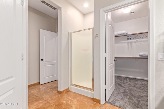 139 E Gail Dr, Gilbert, AZ 85296 - bathroom with a stall shower, a walk in closet, baseboards, and tile patterned floors