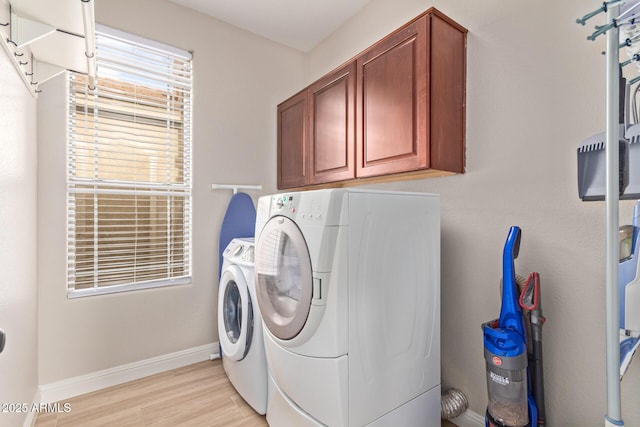 139 E Gail Dr, Gilbert, AZ 85296 - washroom featuring cabinet space, washing machine and clothes dryer, baseboards, and light wood-type flooring