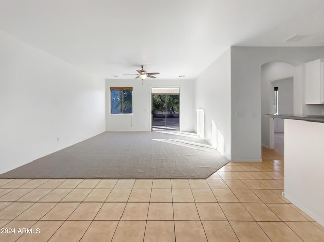 unfurnished living room with ceiling fan and light carpet