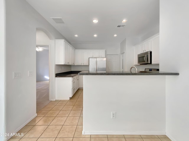 kitchen with white cabinetry, ceiling fan, stainless steel appliances, kitchen peninsula, and light tile patterned floors