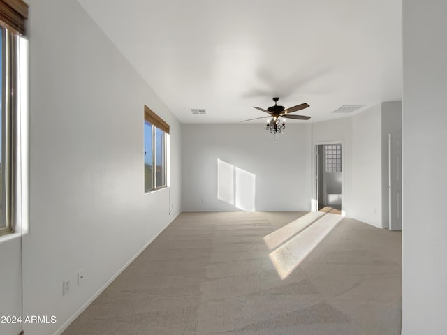 unfurnished room featuring ceiling fan and light colored carpet