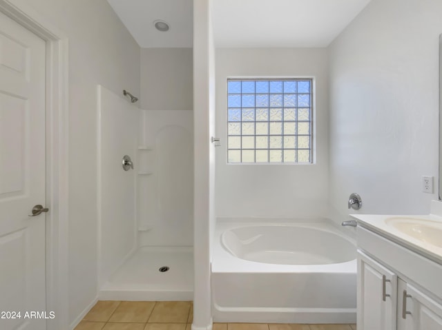 bathroom with tile patterned floors, vanity, and plus walk in shower