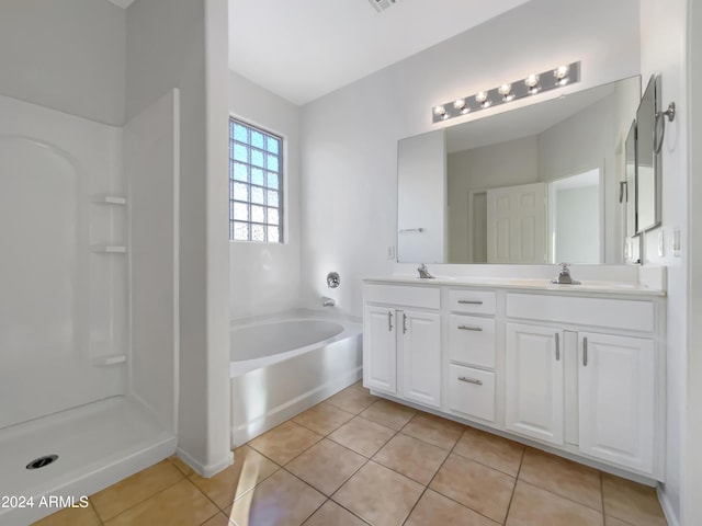 bathroom featuring a tub to relax in, tile patterned flooring, and vanity