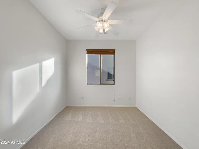 unfurnished room with ceiling fan and light colored carpet