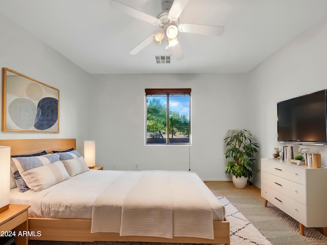 bedroom with ceiling fan and light carpet