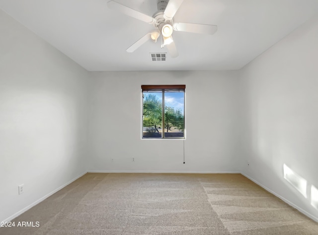 unfurnished room with ceiling fan and light colored carpet