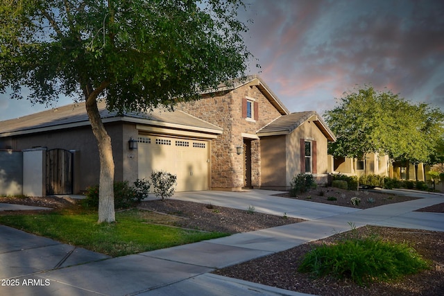 2727 N Acacia Way, Buckeye, AZ 85396 - view of front of home featuring stone siding, a garage, stucco siding, concrete driveway, and a tile roof