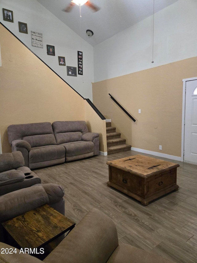 living room featuring high vaulted ceiling, hardwood / wood-style flooring, and ceiling fan