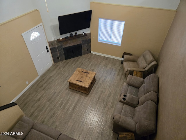 living room featuring hardwood / wood-style floors and a tile fireplace