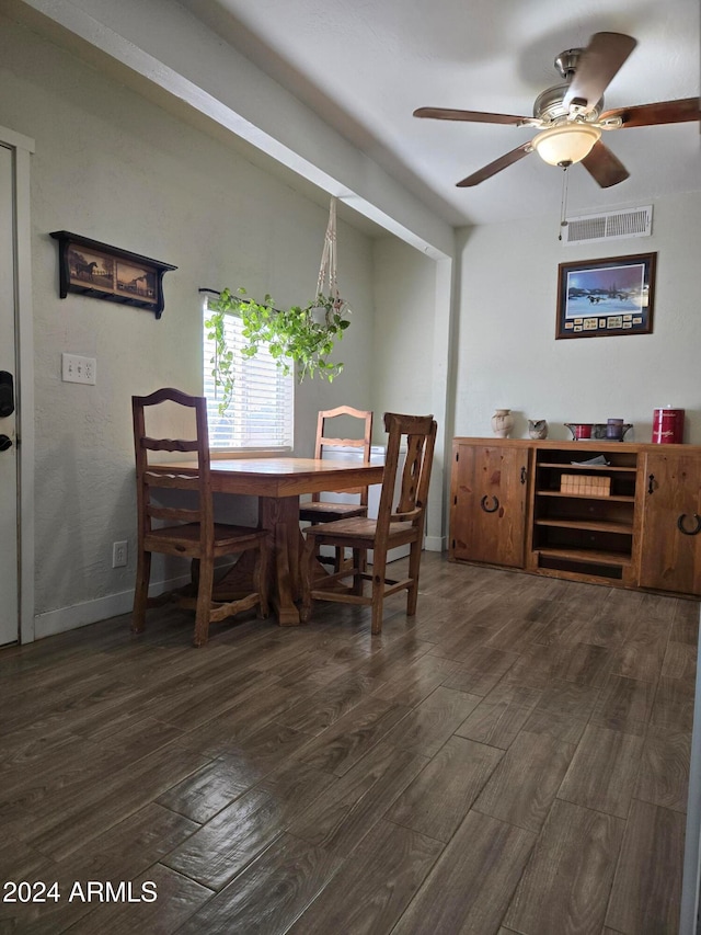 dining room with ceiling fan and dark hardwood / wood-style floors