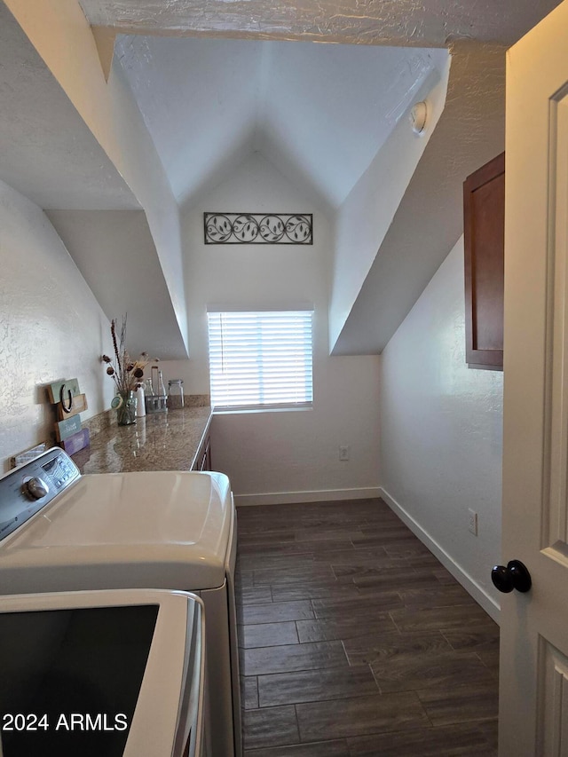 washroom featuring dark wood-type flooring, a textured ceiling, and washing machine and clothes dryer