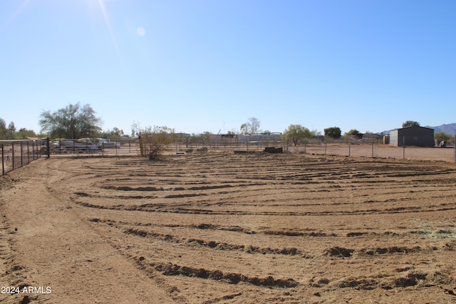 view of yard with a rural view