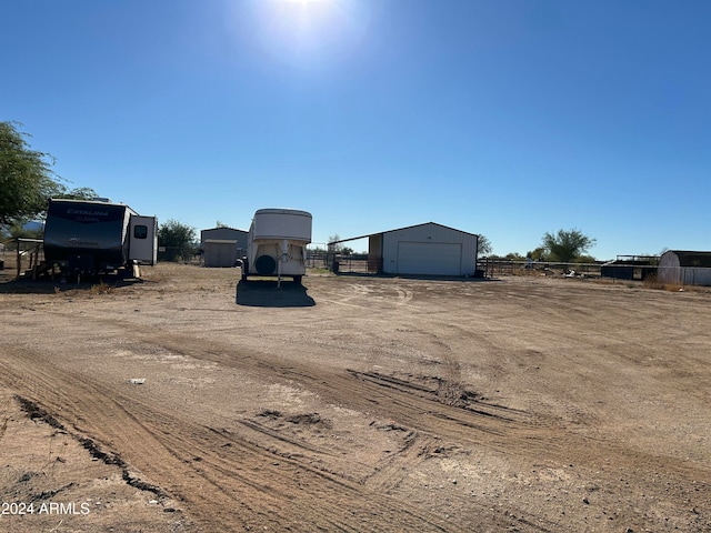 view of yard with a garage and an outdoor structure