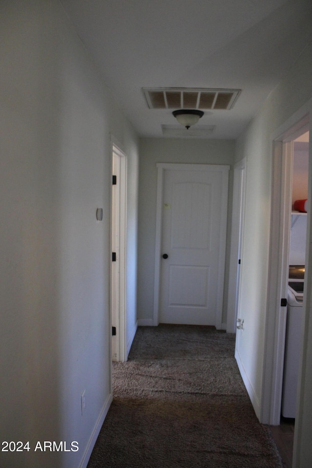 corridor with dark colored carpet