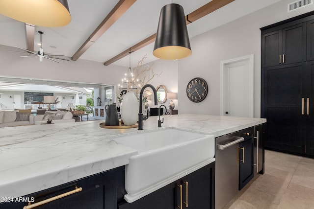 kitchen featuring beam ceiling, ceiling fan, sink, hanging light fixtures, and light stone counters