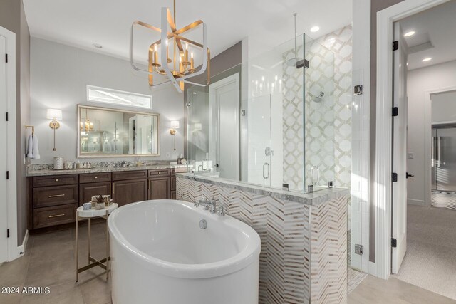 bathroom featuring tile patterned floors, vanity, a chandelier, and shower with separate bathtub