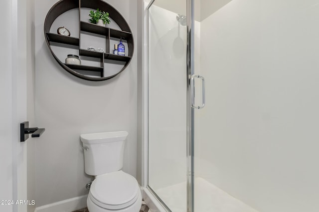 bathroom with toilet and walk in shower