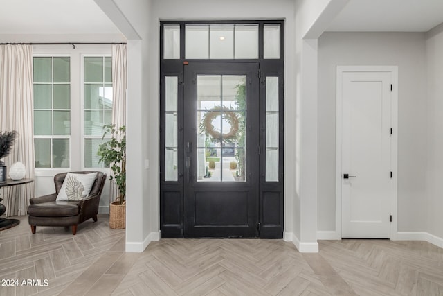 entryway featuring a wealth of natural light and light parquet flooring