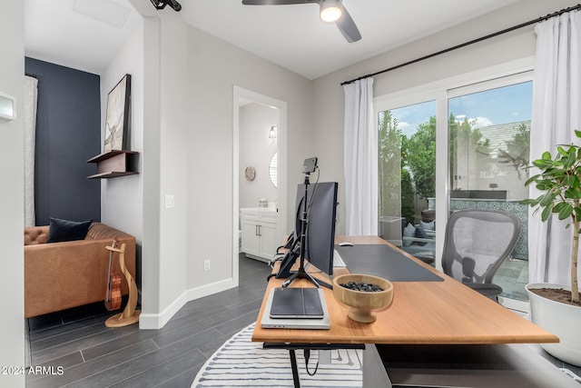 home office featuring dark hardwood / wood-style flooring and ceiling fan