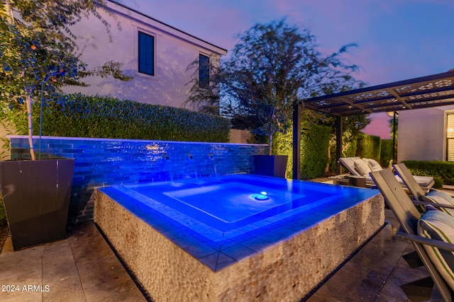 pool at dusk featuring a pergola, a patio area, and an in ground hot tub