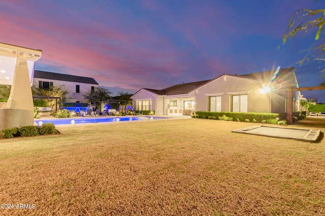 yard at dusk with pool water feature