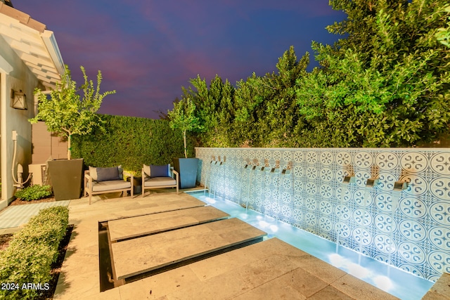 view of patio terrace at dusk