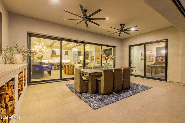 interior space with ceiling fan with notable chandelier and light tile patterned flooring