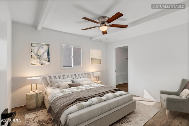 bedroom with ceiling fan, beamed ceiling, and wood finished floors