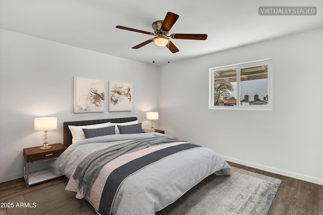 bedroom with wood finished floors, a ceiling fan, and baseboards